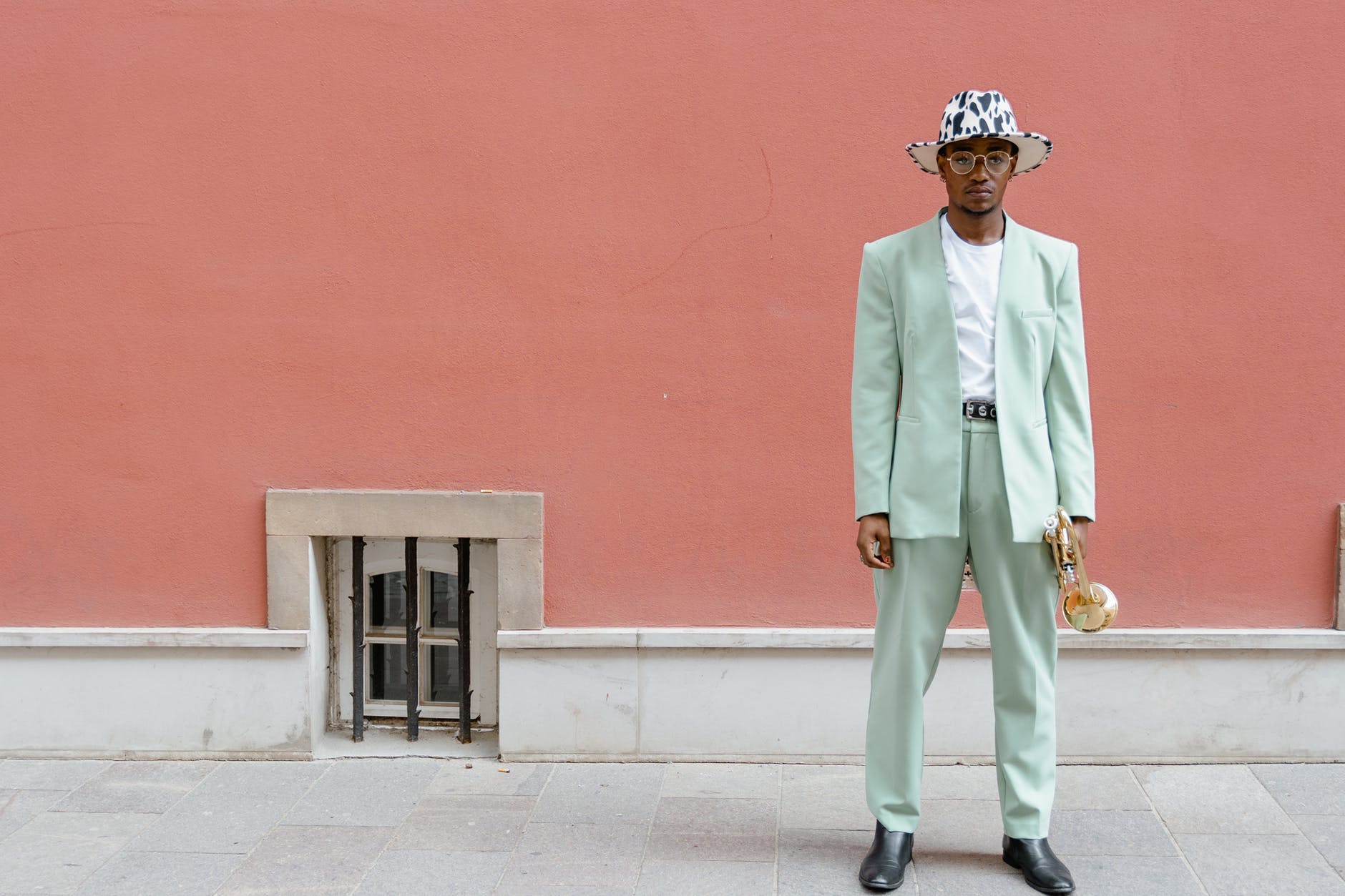 man in suit holding a trumpet