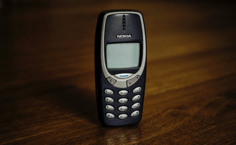 retro cellphone with buttons placed on table