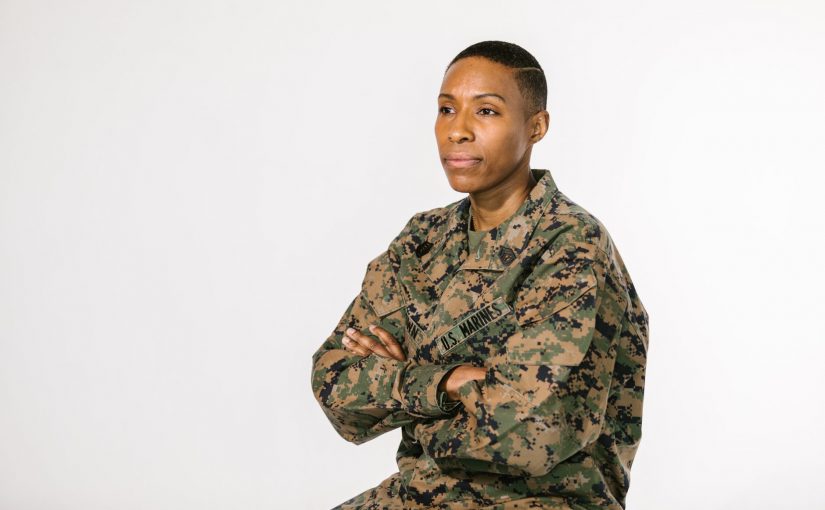 photo of soldier in green and brown camouflage uniform